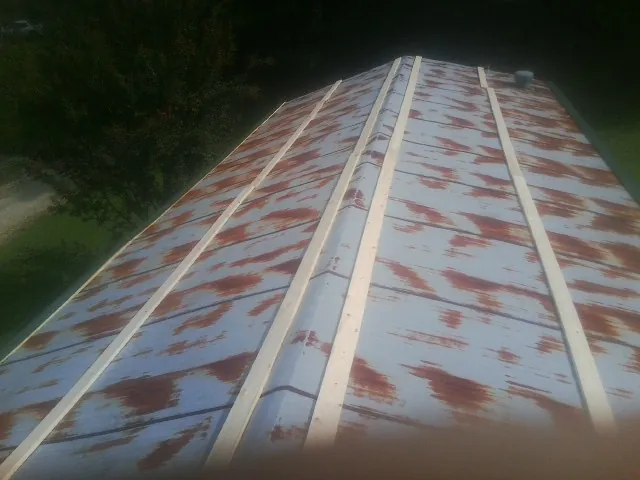 Rusted metal roof panels with new wood purlins before replacement — Storm Damage Roof Repair in Sinai by Roofing Brothers